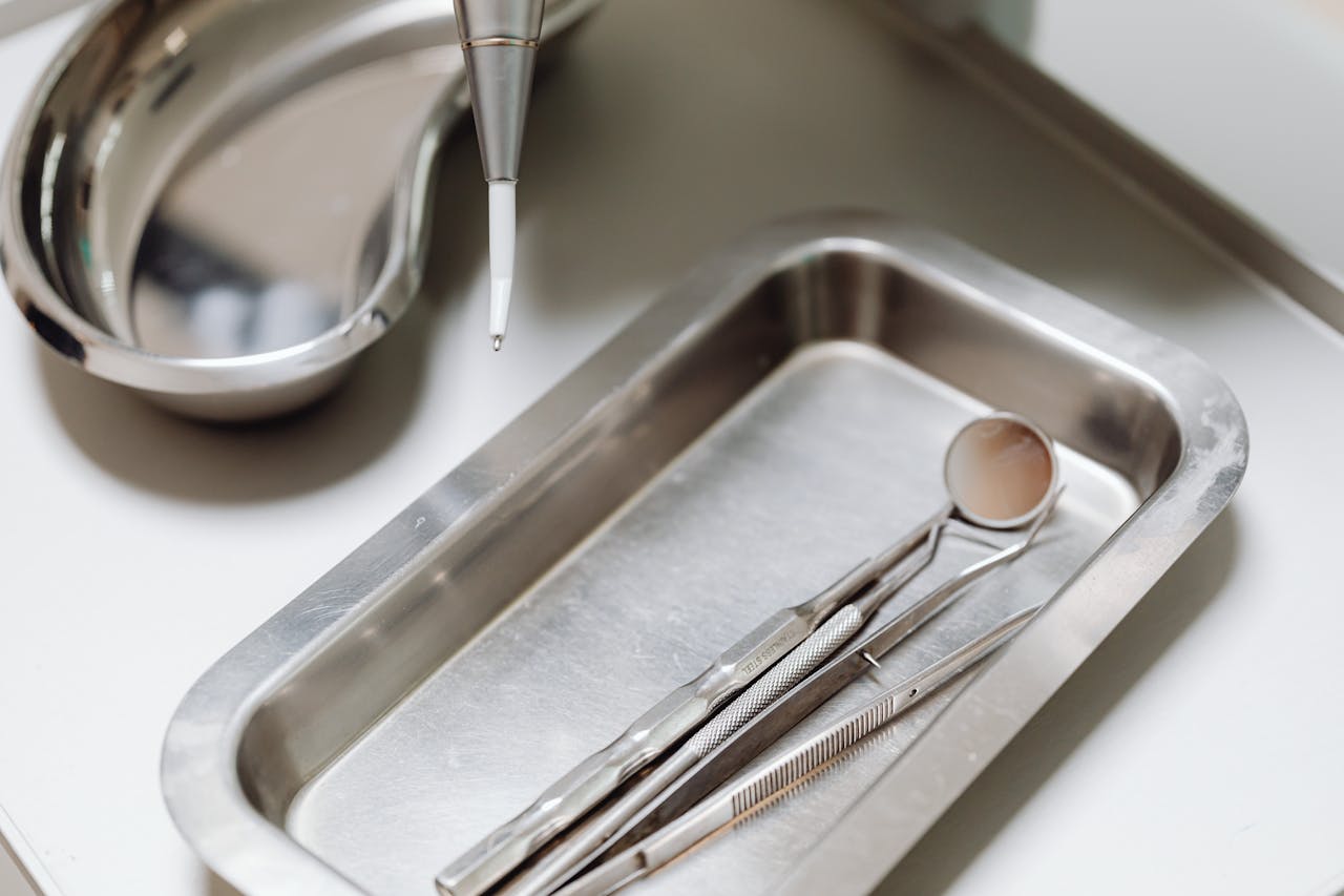 portfolio-04 Close-up of dental tools on a clean, sterile metal tray, emphasizing hygiene and precision.